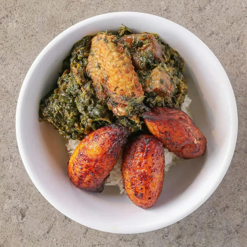 Incred-A-Bowl Food Co's healthy bowl with chicken, greens, and plantains over rice.